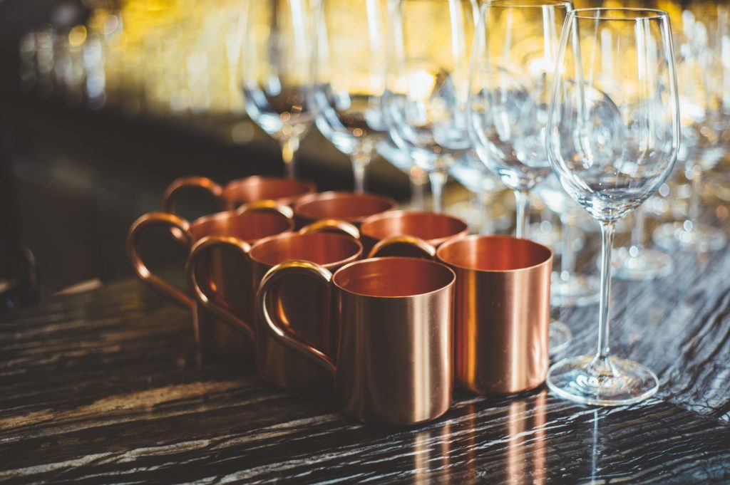 Brass cups and glasses on table